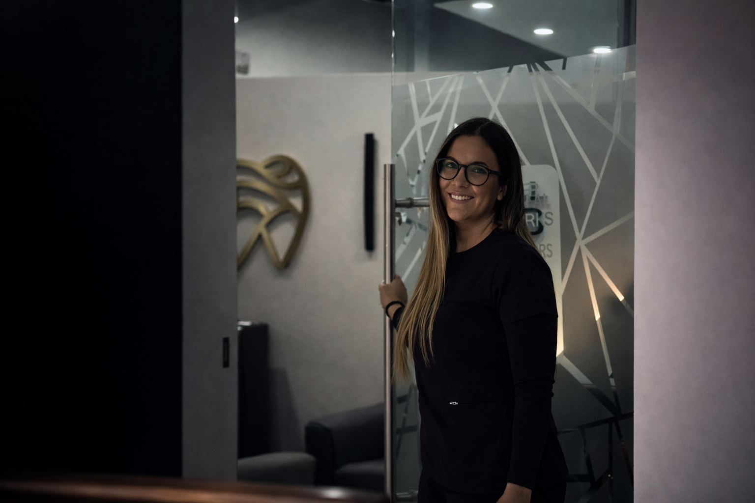 A member of the Interdental Works team at the clinic entrance